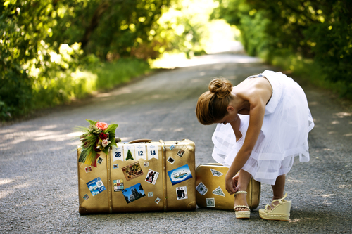 a Beautiful redhead bride with suitcases