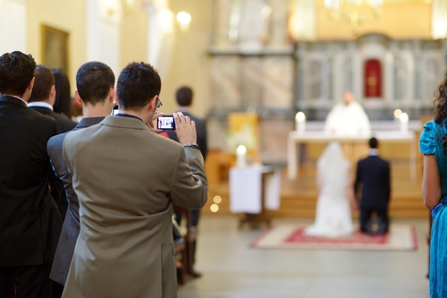 Wedding guest taking photos on a wedding ceremony